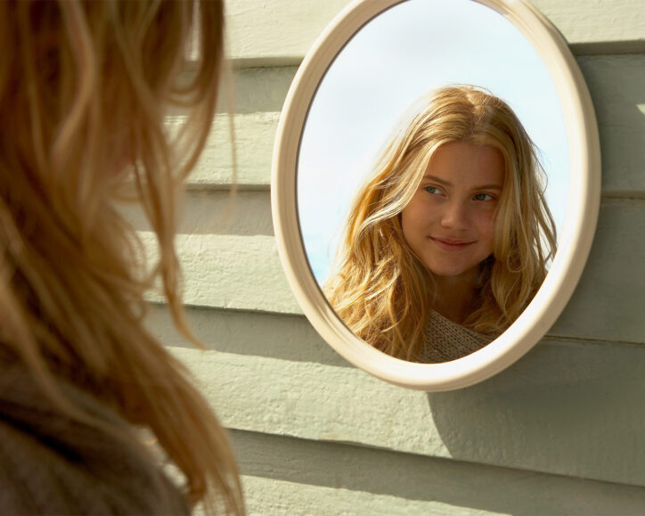 child looking in a mirror
