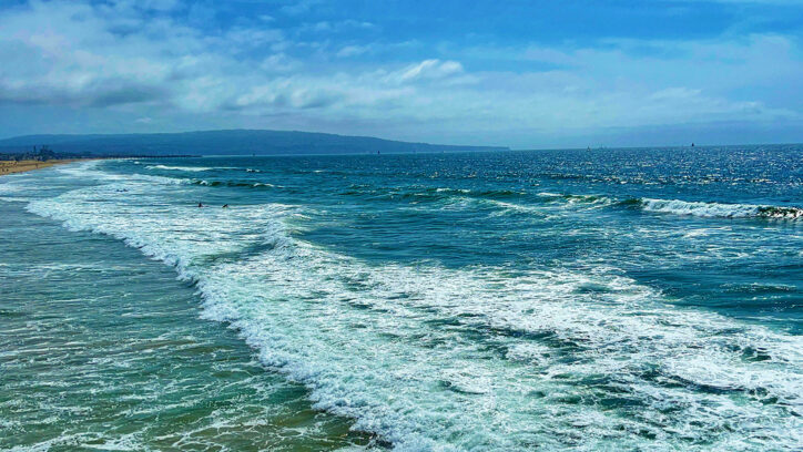 Photo of ocean wave breaking on shore